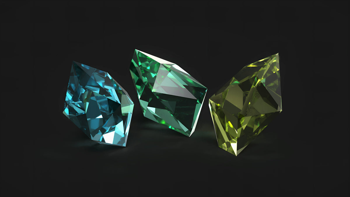 Three cut gemstones in blue, green and lime on a black background